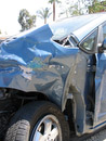 The first collision pushed us into the carpool lane, where the front of the car was hit again by a very large and solid gardening truck.  You can tell that the front of the truck was painted green and white by looking at the paint scrape it left on what's left of the front fender.